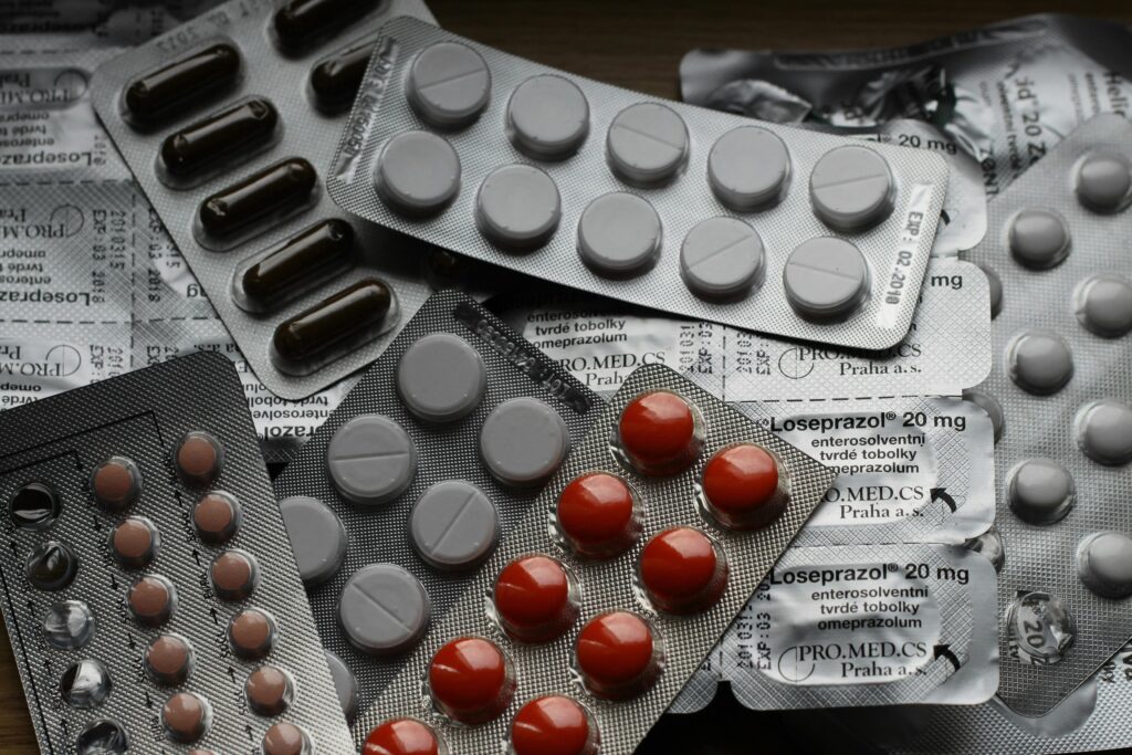 pexels-photo-208512-208512 Close-up of various pills in blister packs showcasing medical and healthcare themes.